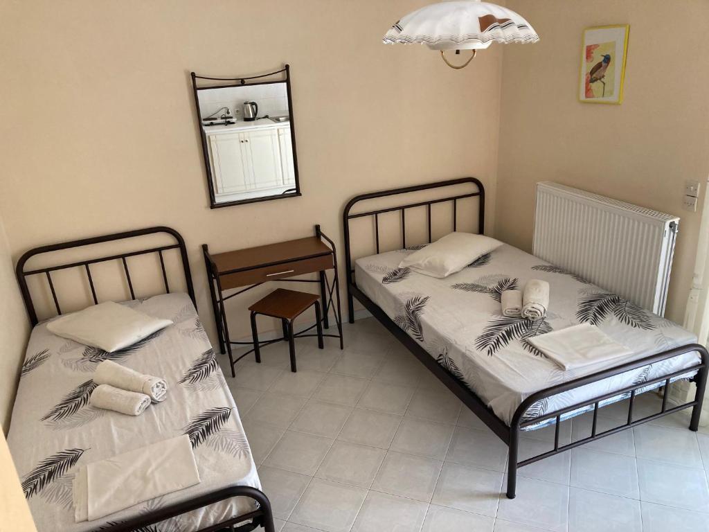 Postel nebo postele na pokoji v ubytování Polyxenis Rooms