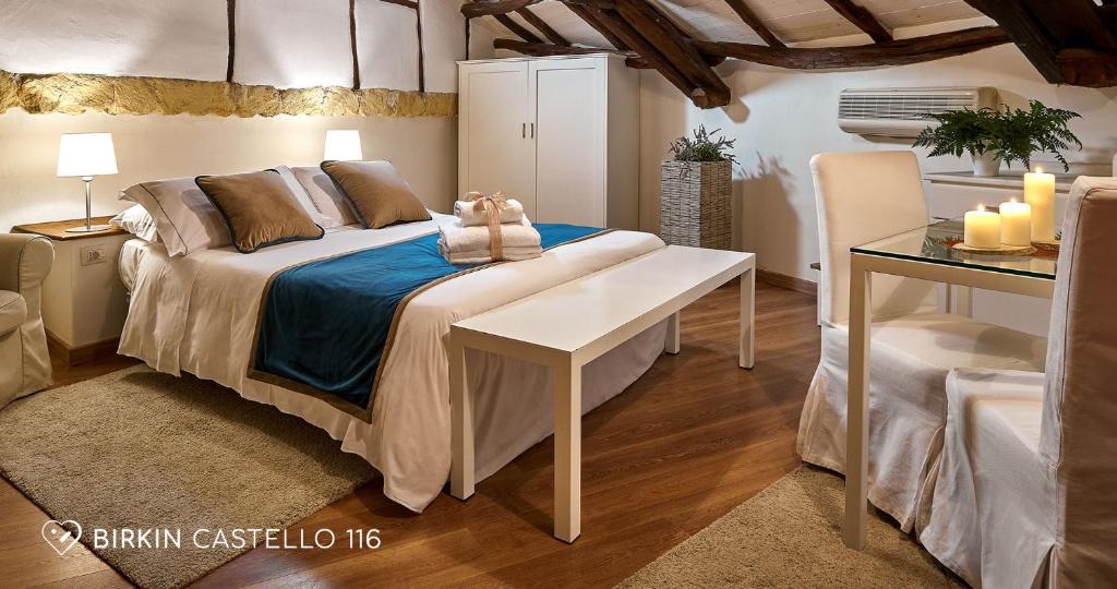 a bedroom with a bed and a table with candles at Albergo Diffuso Birkin Castello in Cagliari