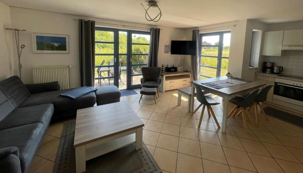 a living room with a couch and a table at Ferienhaus Rieke in Friedrichskoog-Spitze