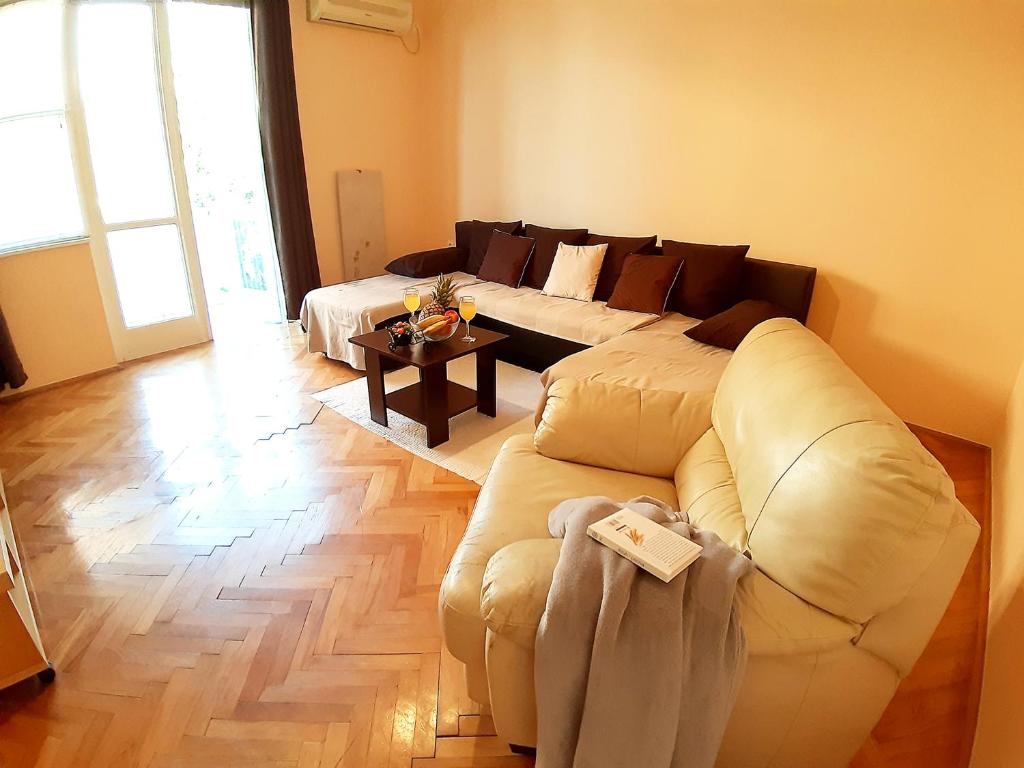 a living room with a couch and a table at Amarena Apartment in Rijeka