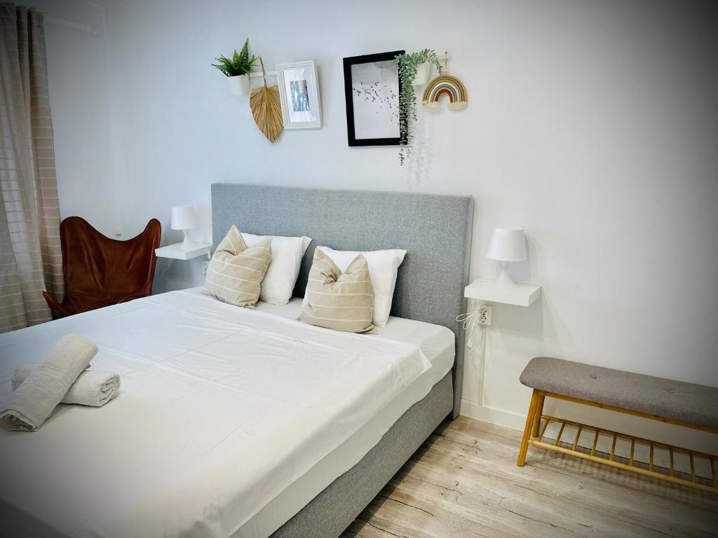 a bedroom with a large bed with white sheets and pillows at Cozy Place to Stay -Self check in 24h in Reşiţa