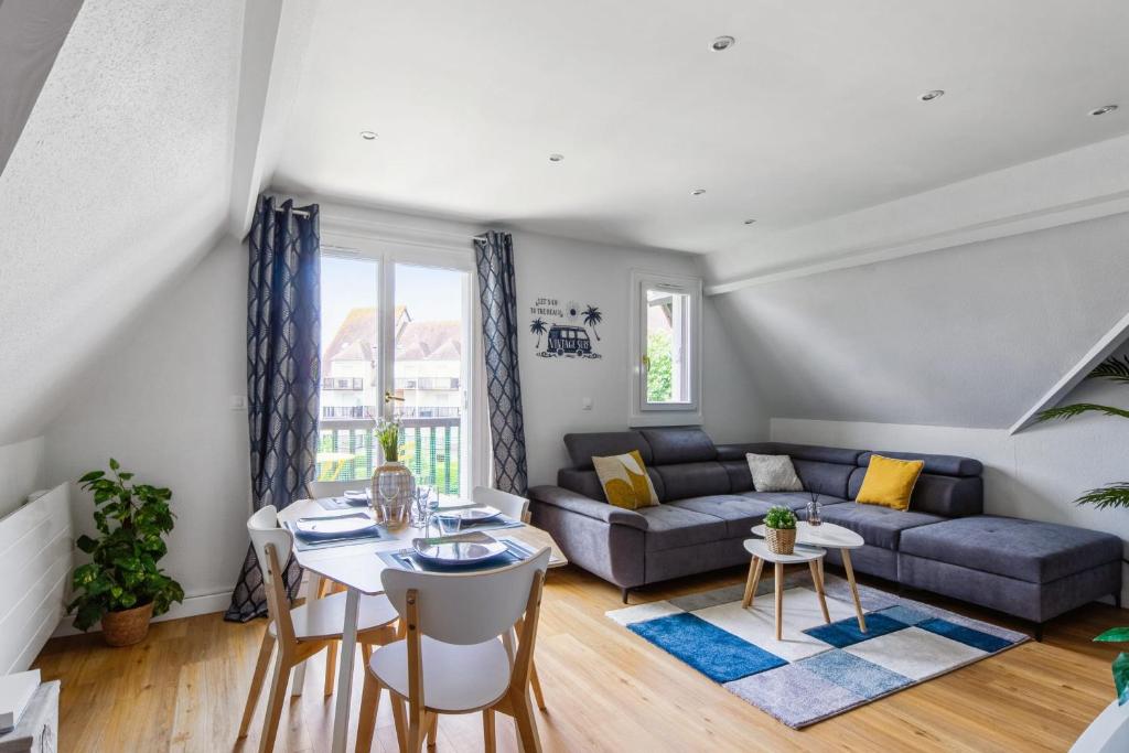 - un salon avec un canapé et une table dans l'établissement Beautiful duplex with balcony in Cabourg - Welkeys, à Cabourg