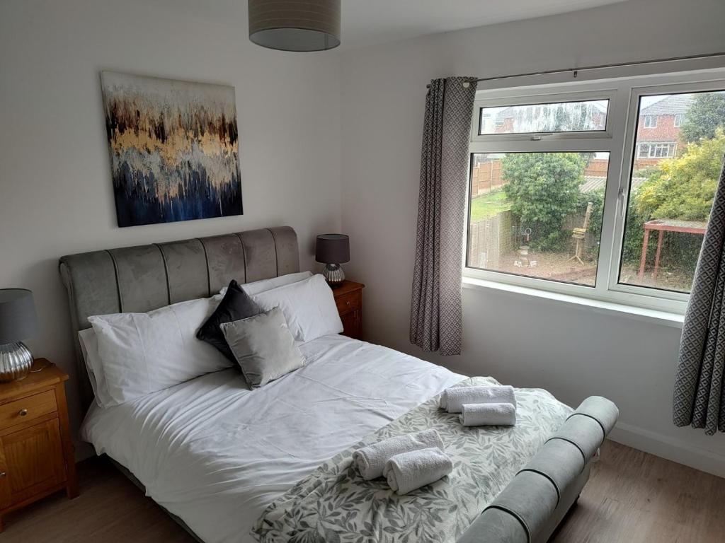 um quarto com uma cama com duas toalhas em Wavertree Drive 3 bed contractor home in Leicester em Leicester