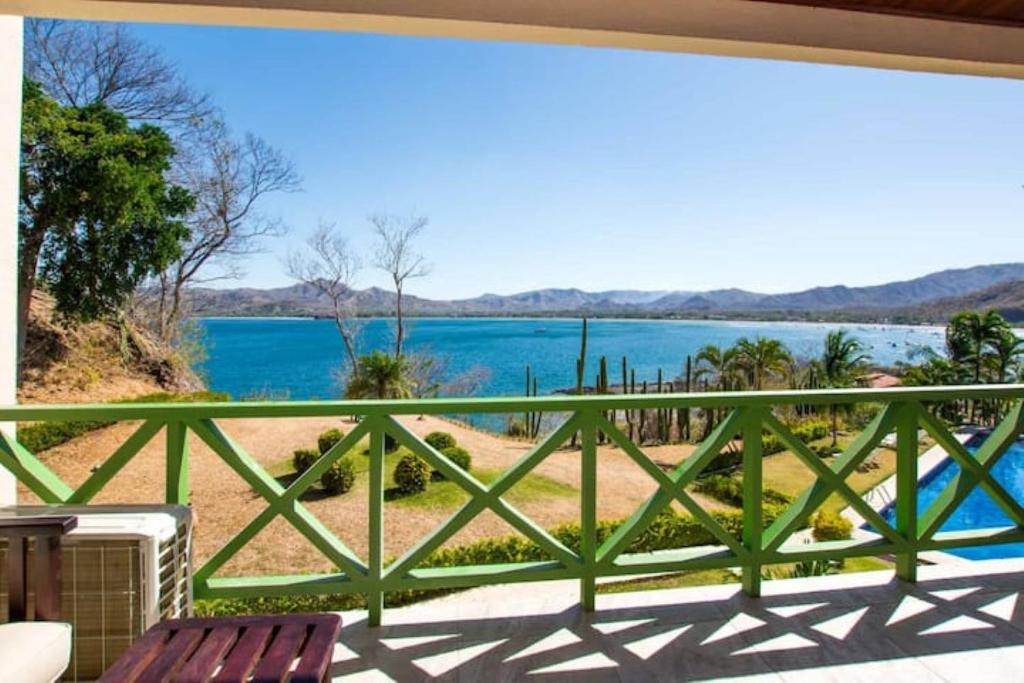 a view of the water from the balcony of a house at Central located in Flamingo, Condo with gorgeous views - Flamingo Marina Resort in Playa Flamingo