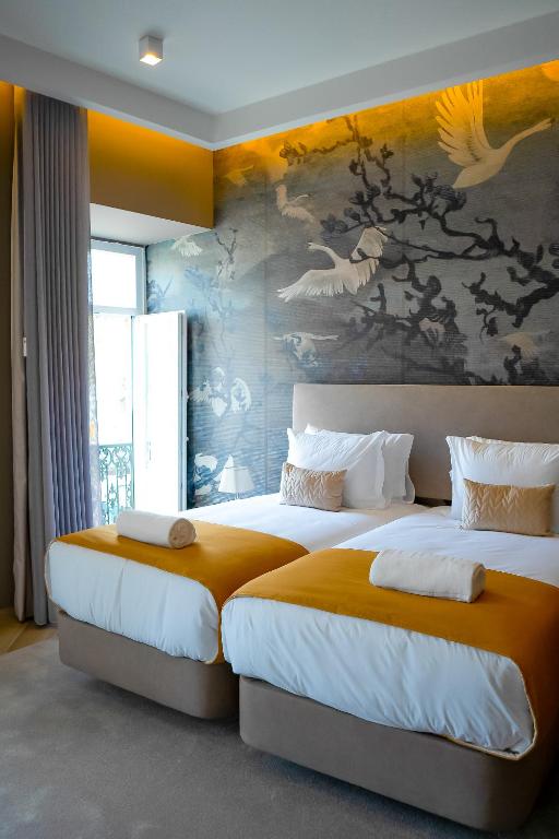 Postel nebo postele na pokoji v ubytování Guest House Jacarandá Faro