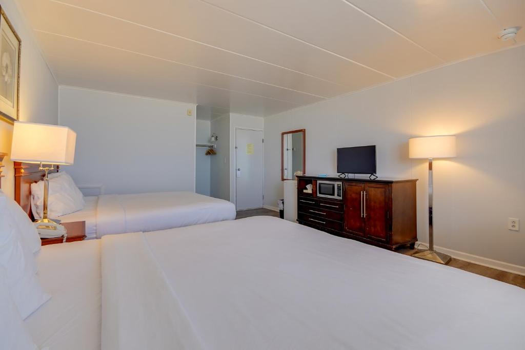 a hotel room with two beds and a television at Rideau Oceanfront Motel in Ocean City