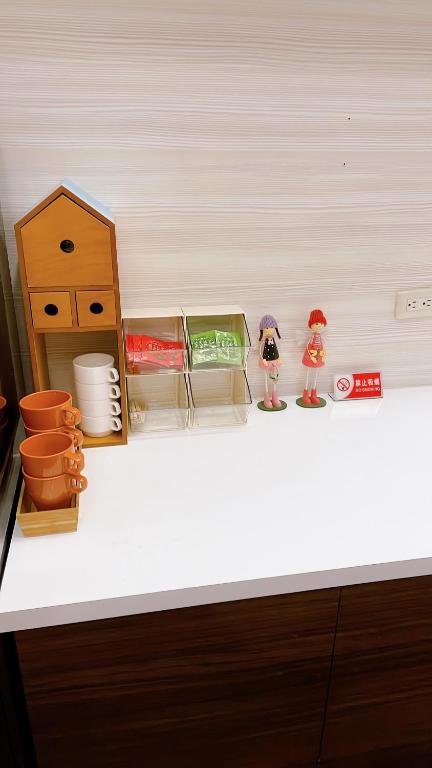 a white counter top with some toy figurines on it at Sun B&amp;B in Taitung City