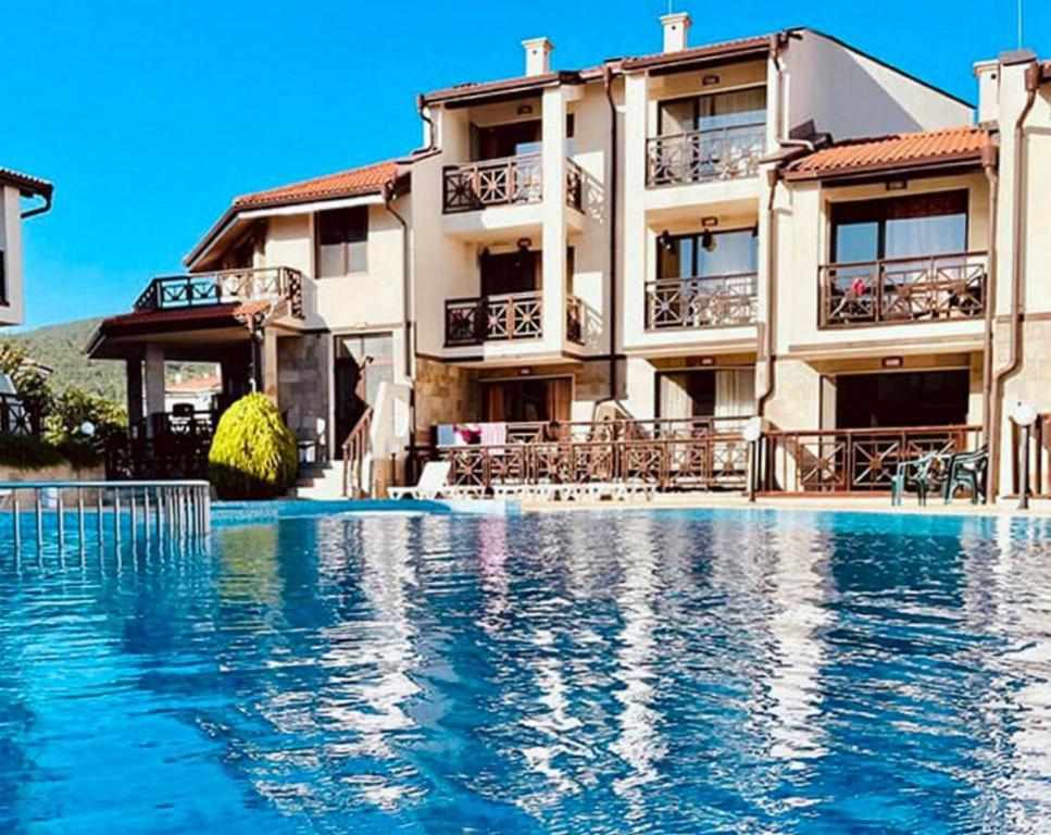 un hôtel avec une piscine en face d'un bâtiment dans l'établissement Dream Villa in Imperial Heights Villas, à Sunny Beach