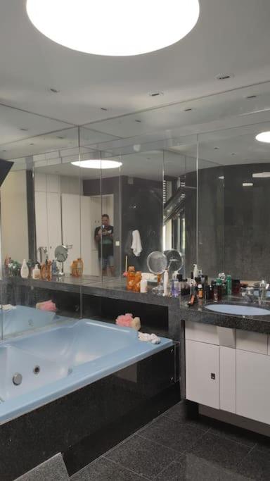 a large bathroom with a tub and a large mirror at Maginifique villa d&#39;architecte sur les bords de Marne tout près de Paris in Le Perreux-Sur-Marne