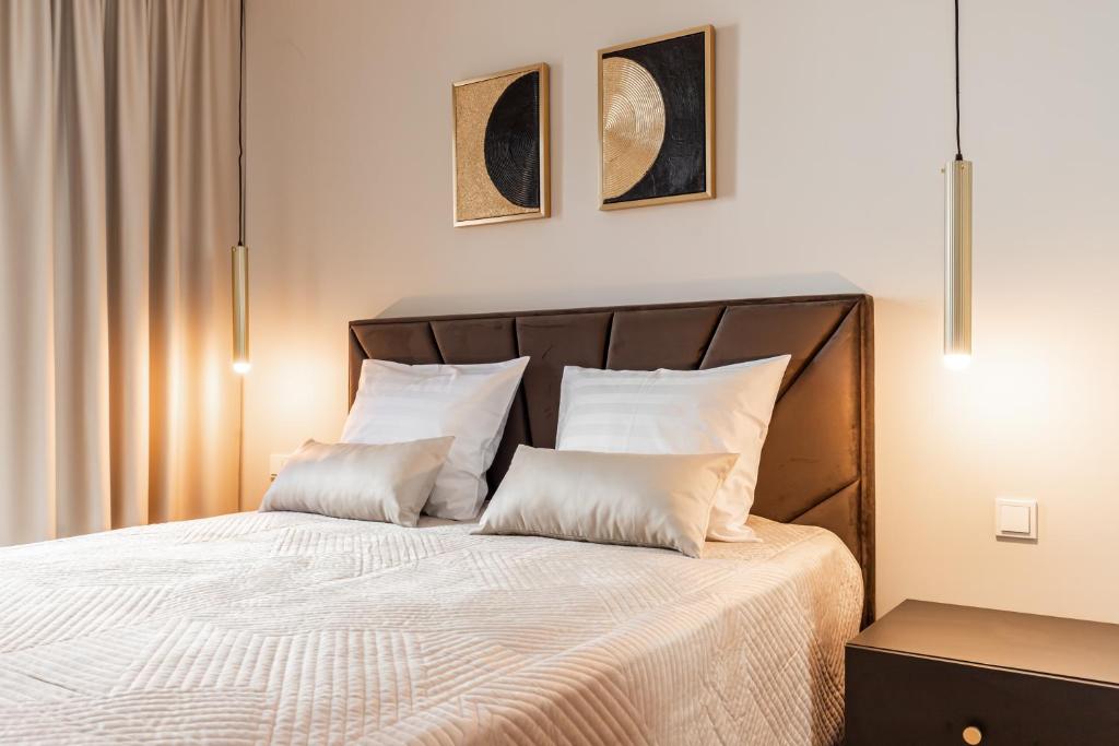 a bedroom with a bed with two pillows at Laulupargi Lux Residence in Tallinn