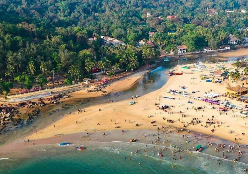 an aerial view of a beach with people on it at Baga View Inn in Baga