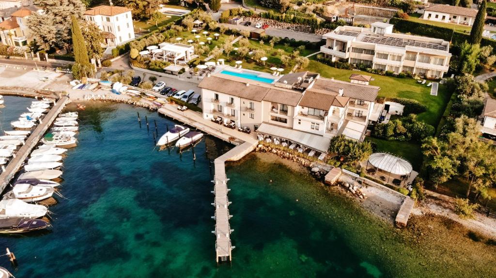 an aerial view of a marina with boats in the water at Bella Hotel & Restaurant with private dock for mooring boats in San Felice del Benaco
