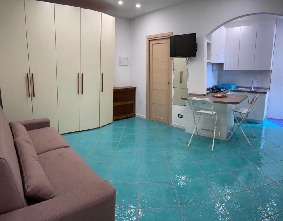a living room with a couch and a table and a kitchen at Ischia Dream Loft da Nancy in Ischia
