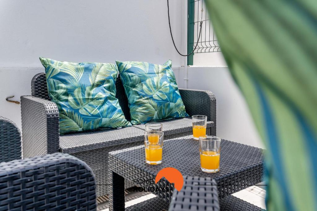 two glasses of orange juice sitting on a table at #183 Private Terrace Oldtown with AC in Albufeira