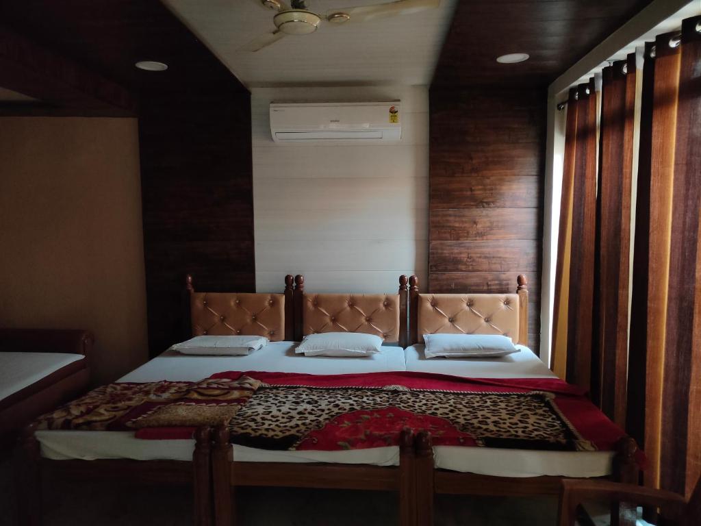 a bedroom with a large bed with a wooden wall at Hotel Shubhadra Guest House in Mathura