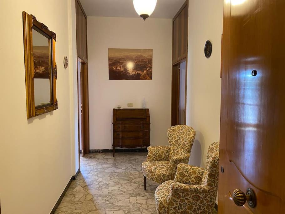 a hallway with two chairs and a mirror and a dresser at DodoHouse2 in Amandola