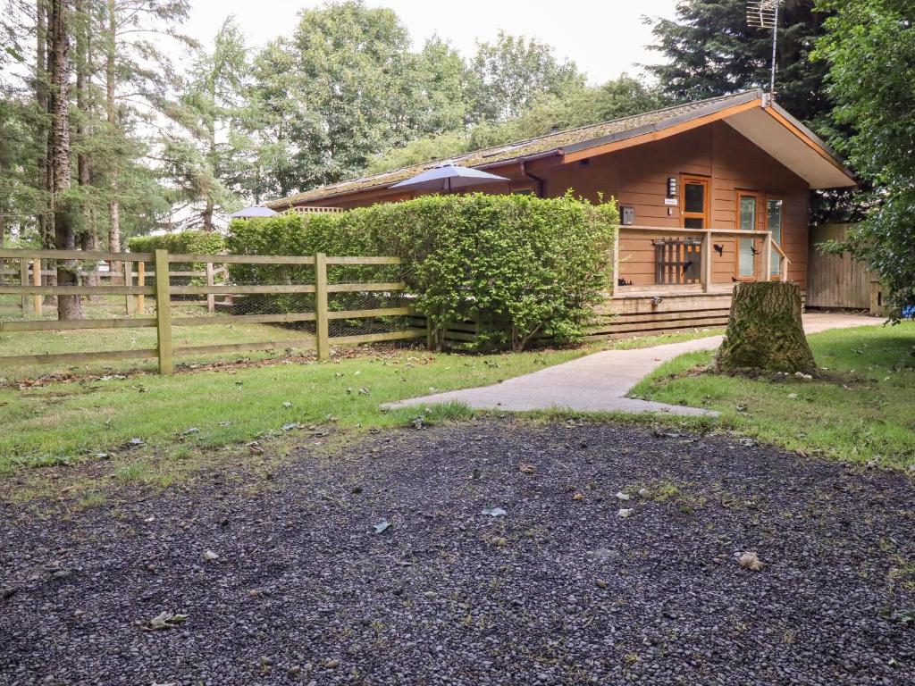 a log cabin with a path leading to it at Swinsty Lodge in Harrogate