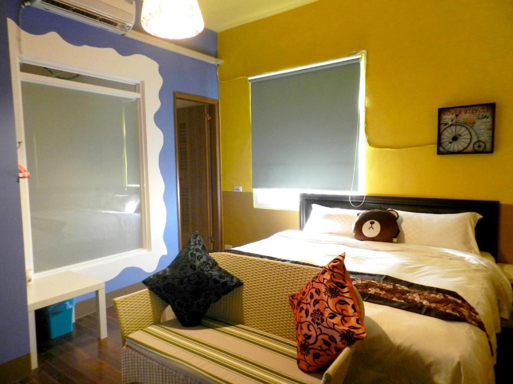 a bedroom with a bed with a clock on the wall at Home in Hengchun Homestay in Hengchun South Gate