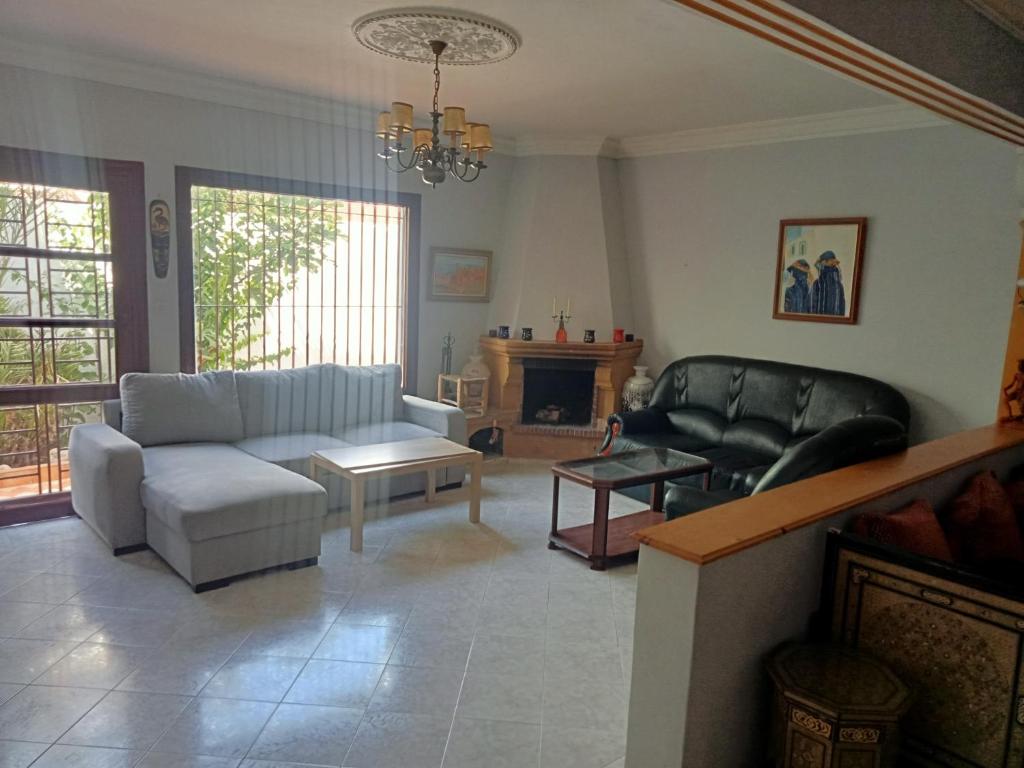 a living room with a couch and a table at Villa sidi Bouzid in El Jadida