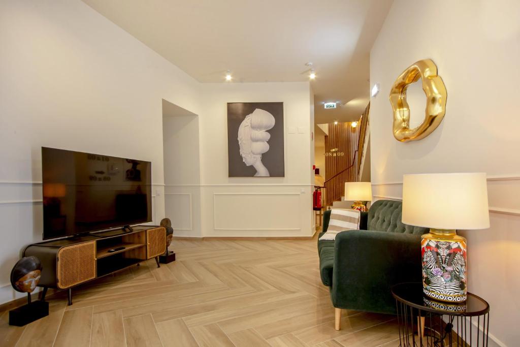 TV a/nebo společenská místnost v ubytování Guest House Jacarandá Faro