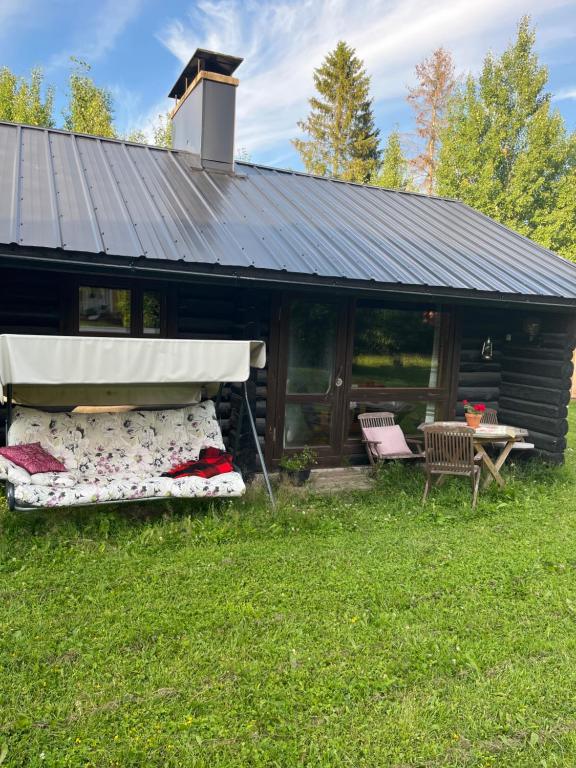 a house with two mattresses in front of it at Valkolan kartanon saunatupa, yksi huone ja sauna in Hankasalmi
