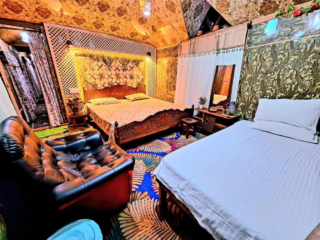 a bedroom with a bed and a chair in it at HB king of kings in Srinagar