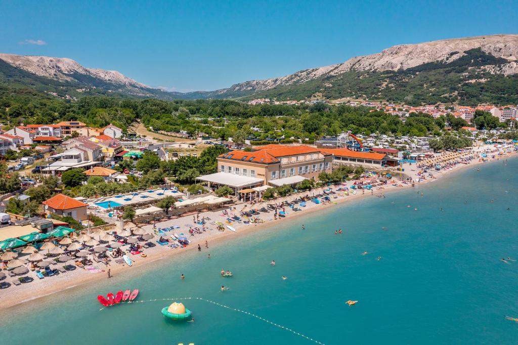 an aerial view of a beach in a resort at Hotel Dobrovit in Baška