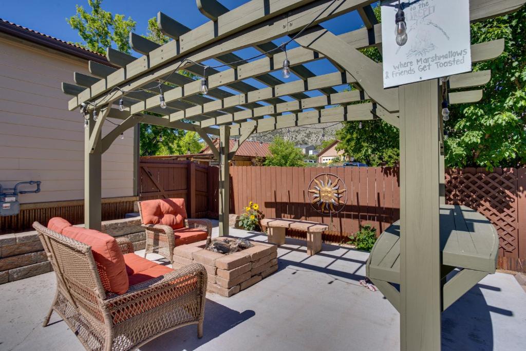 a pergola on a patio with two chairs and a fire pit at Spacious Vacation Home 5 Mi to Ridgway State Park in Ridgway