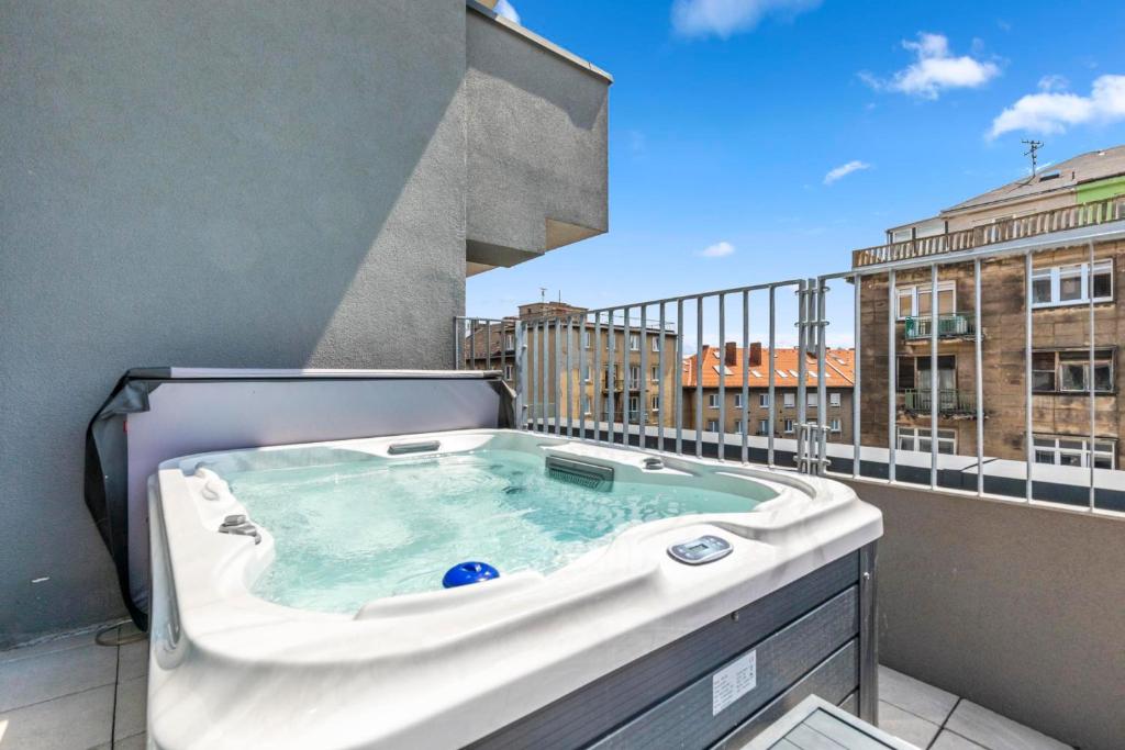 a hot tub on the balcony of a building at LAM Pink with Jacuzzi & PS4 in Bratislava