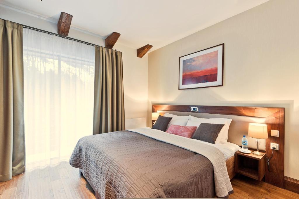 Postel nebo postele na pokoji v ubytování Mevo Apartament