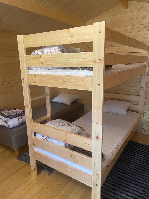 a set of bunk beds in a cabin at Домик на Чудском озере in Katase