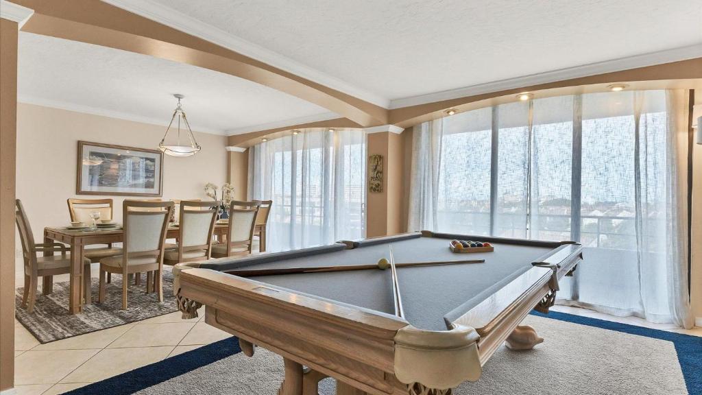 a room with a pool table and a dining room at 6415 Midnight Pass #611 in Siesta Key