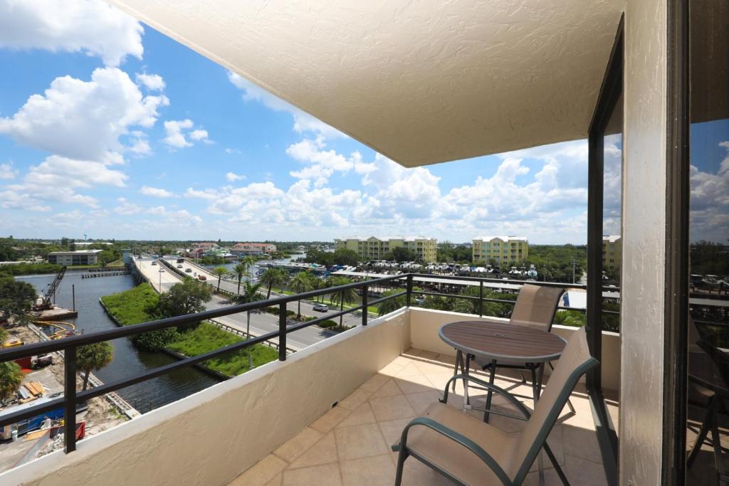 a balcony with a table and chairs and a view of a river at 6415 Midnight Road #709 in Siesta Key