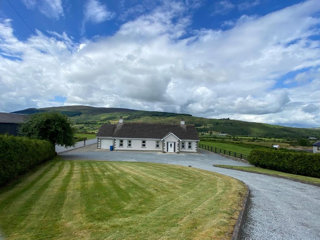 a large white house with a large driveway at Slieve Gullion Valley View in Camlough