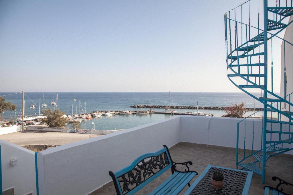 a bench on a balcony with a view of the ocean at Stella's place, Vlichada in Vlychada