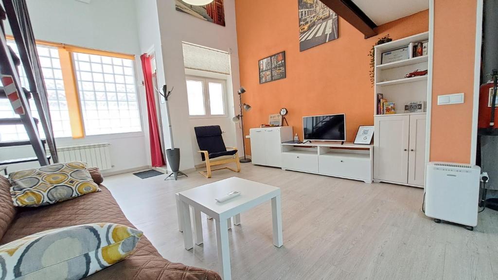 a living room with a couch and a table at La Vaguada loft in Madrid