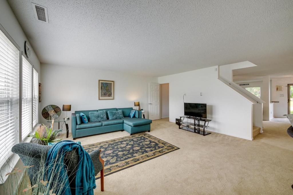 a living room with a blue couch and a tv at Camby Home with 3 Living Areas and Community Pool! in Plainfield