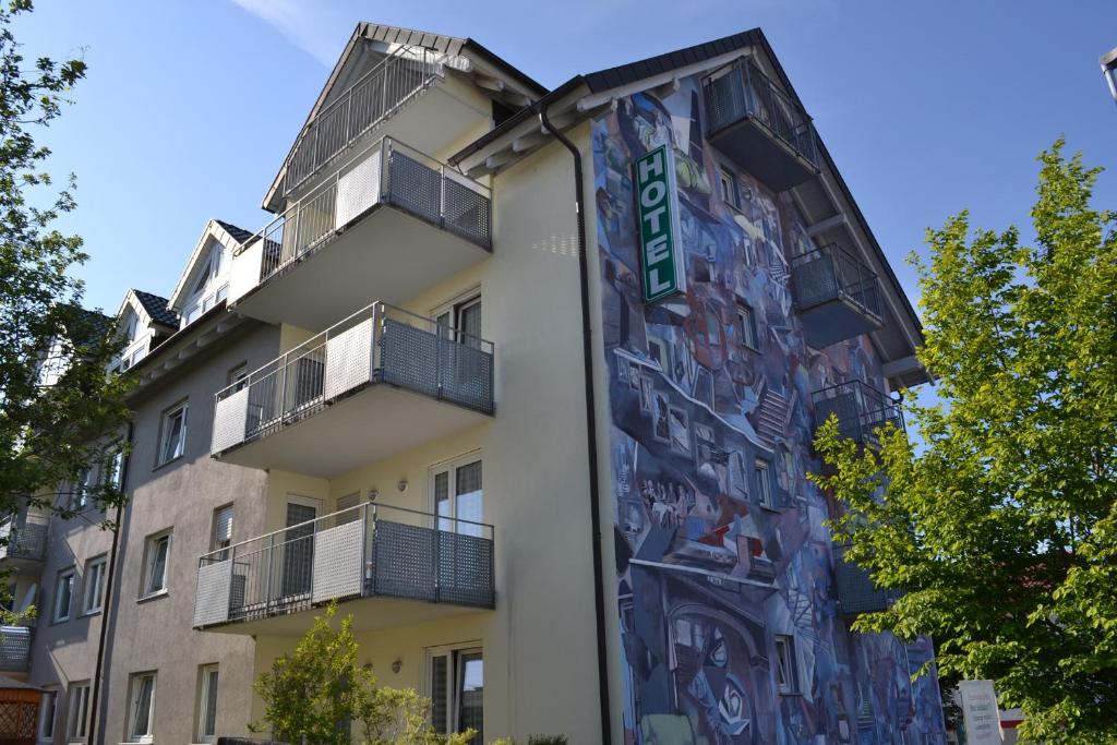 a building with a mural on the side of it at Hotel Relax in Singen