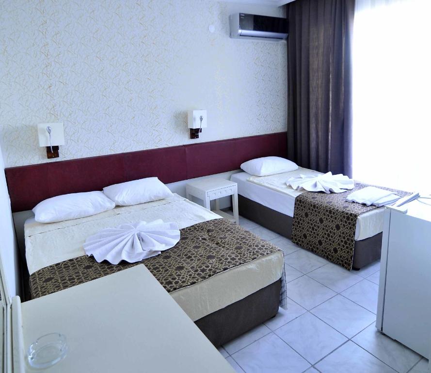 Postel nebo postele na pokoji v ubytování Sun Kiss Hotel