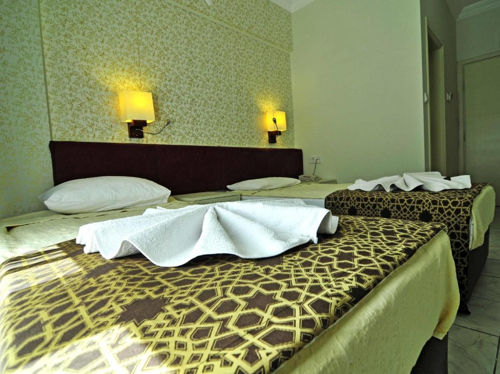 Postel nebo postele na pokoji v ubytování Sun Kiss Hotel