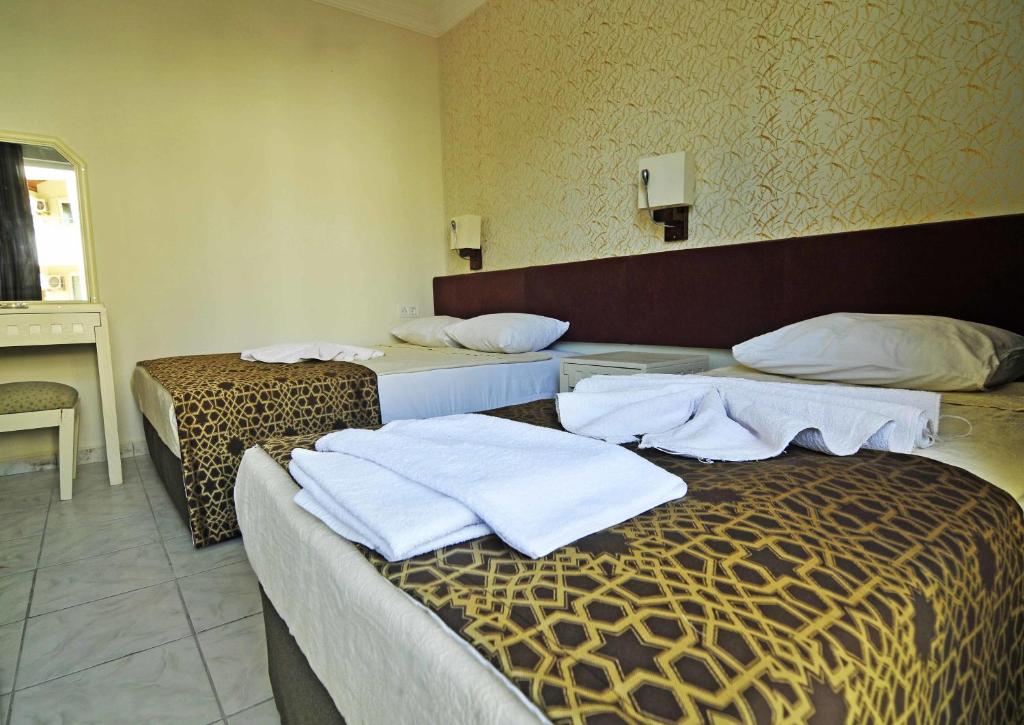 Postel nebo postele na pokoji v ubytování Sun Kiss Hotel
