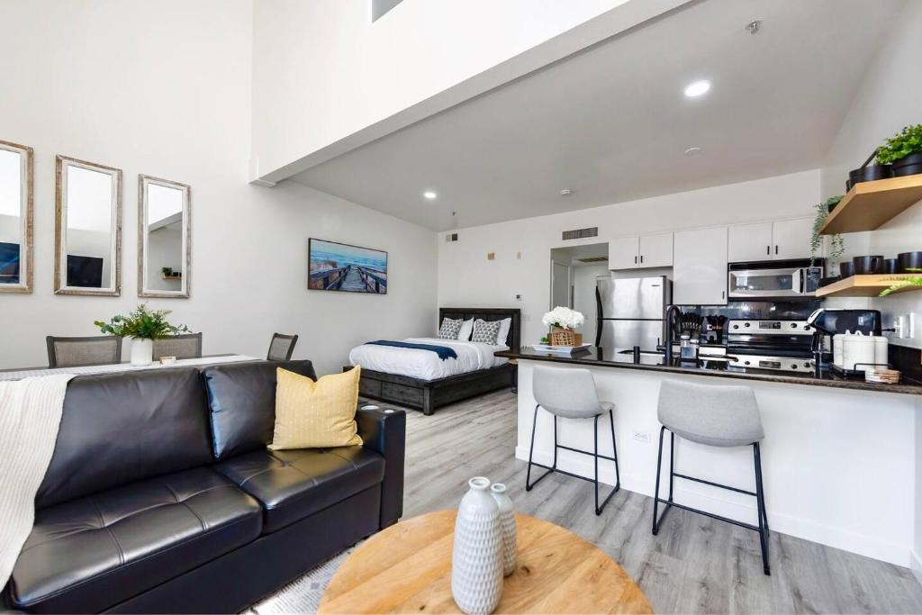 a living room with a couch and a kitchen at Luxurious Condo Walking Distance to San Diego Bay! in San Diego