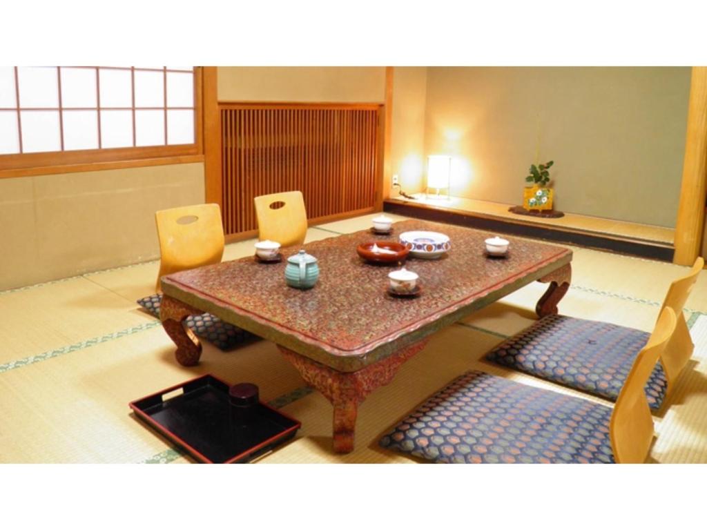 a dining room with a table and two chairs at Shunjuan Kikusui - Vacation STAY 03162v in Chikuma