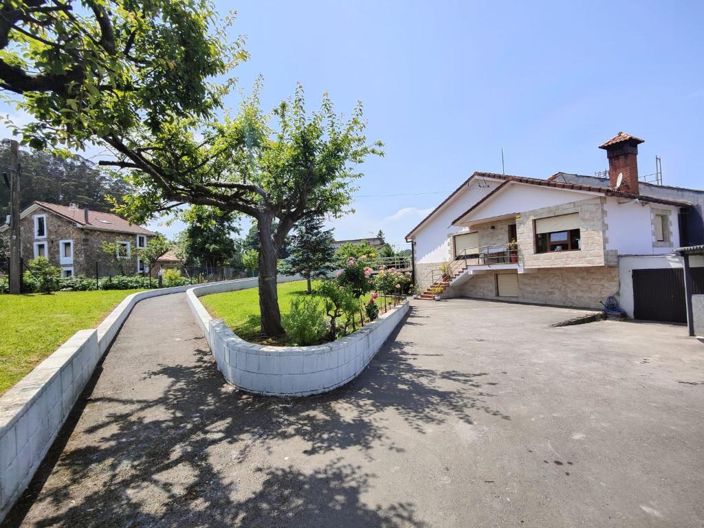 a tree in a planter in front of a house at La Casuca De Mabel in Revilla de Camargo