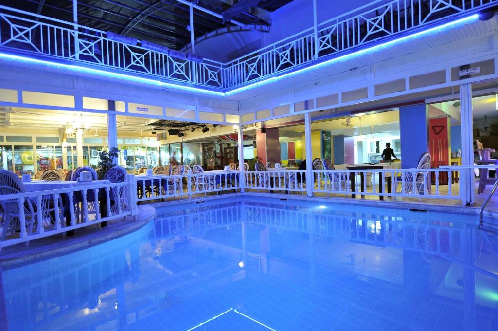 a large swimming pool in a hotel with people sitting at Sun Kiss Hotel in Side
