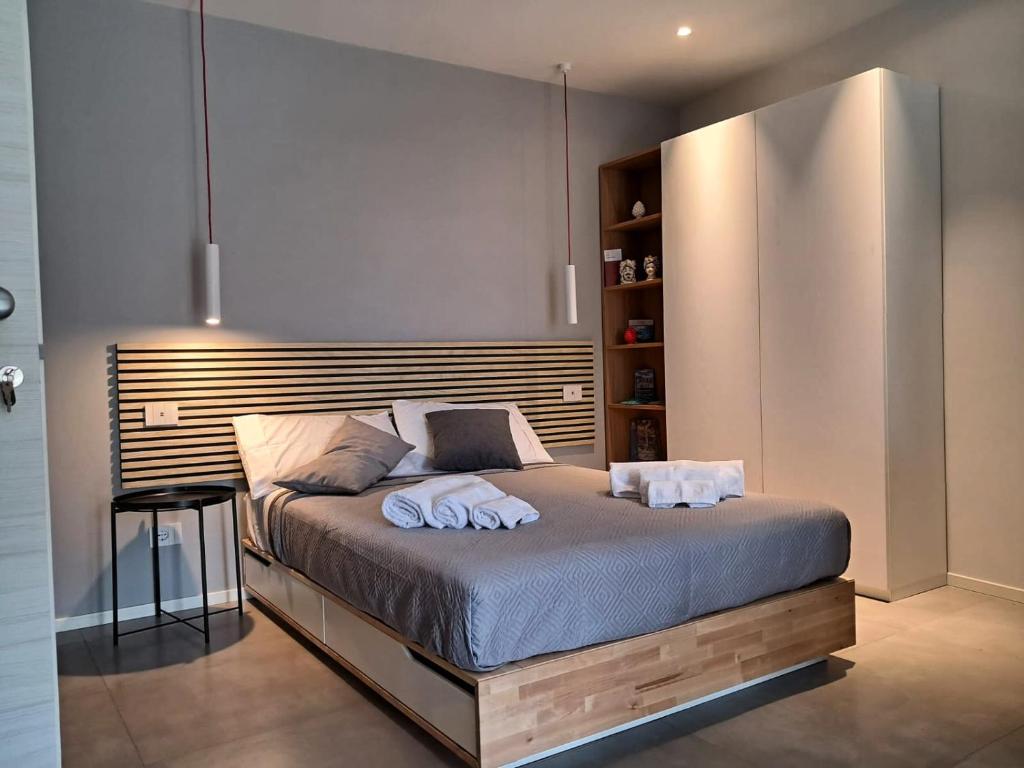 a bedroom with a bed with two towels on it at Porta San Paolo House in Castelbuono