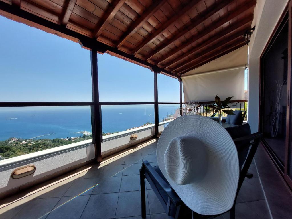 a room with a large window with a view of the ocean at Horizon Studios with Sea View - Free Parking in Glossa