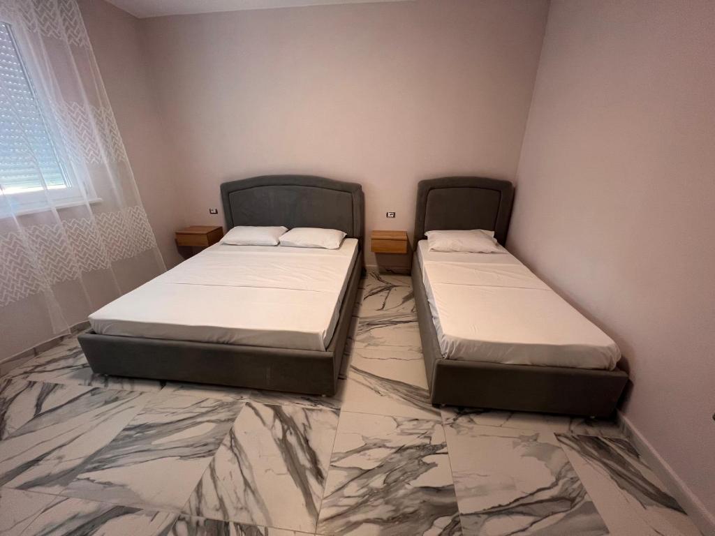 Postel nebo postele na pokoji v ubytování Niki Apartments Shen Gjin