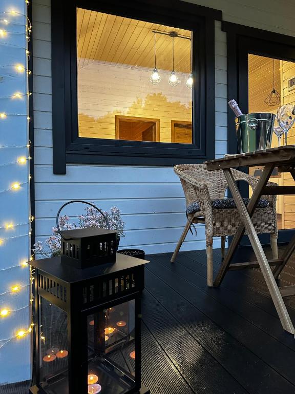 Outdoor seating with lit lanterns and string lights.