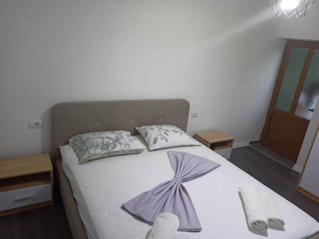 a bedroom with a bed with two pillows on it at Kristina Mitllari 2 in Pogradec